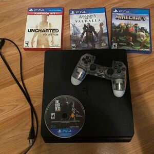 Sony PlayStation 4 with controller cord and 4 games all gently used